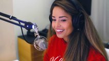 Valkyrae streaming while wearing a red sweater