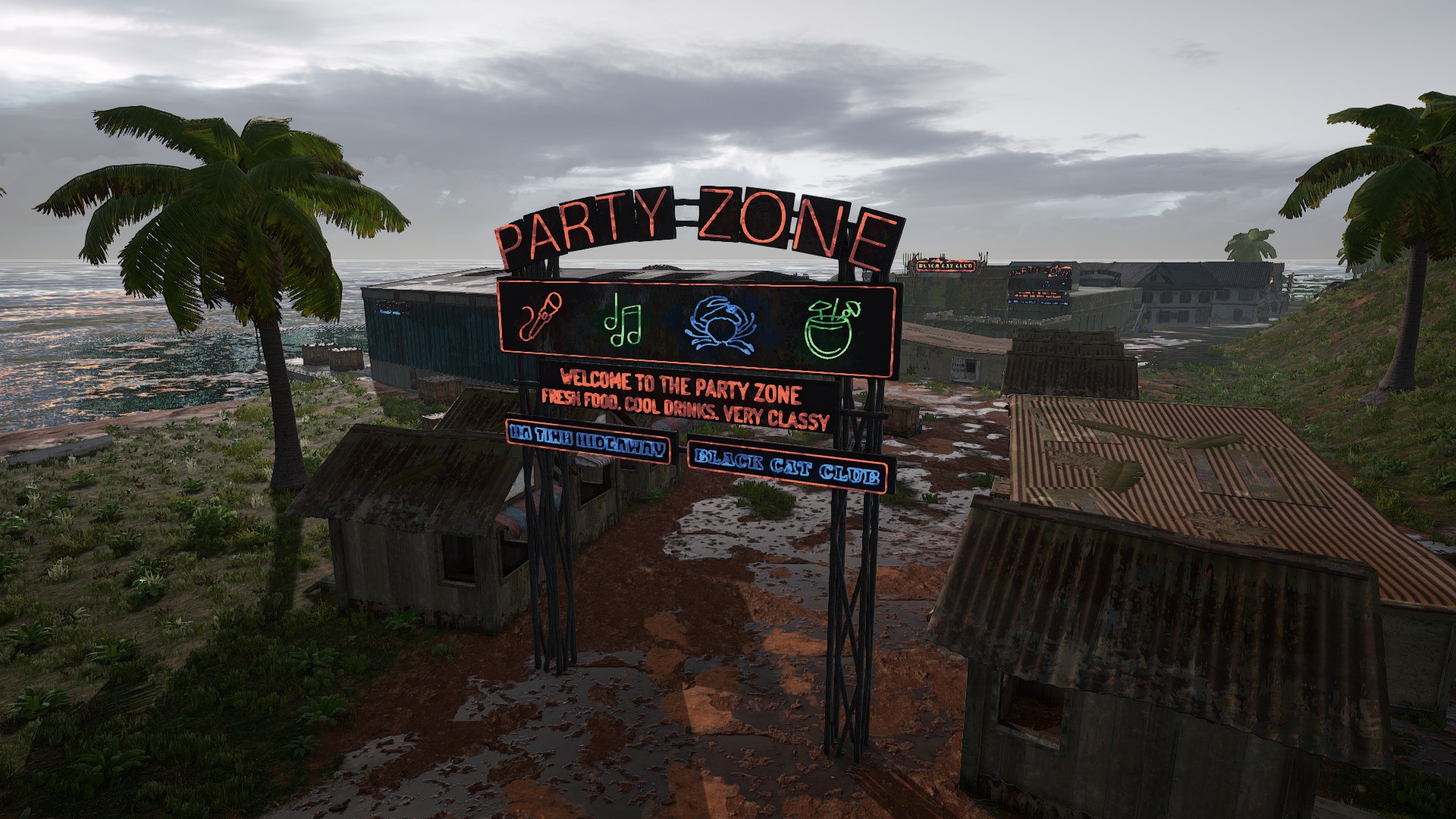 PUBG Sanhok drops: Sanhok's neon sign at the Party Zone, with several small buildings in the background.