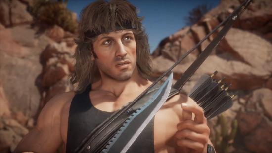 Rambo holding a serrated dagger. He has a bow and some arrows strapped to his back.