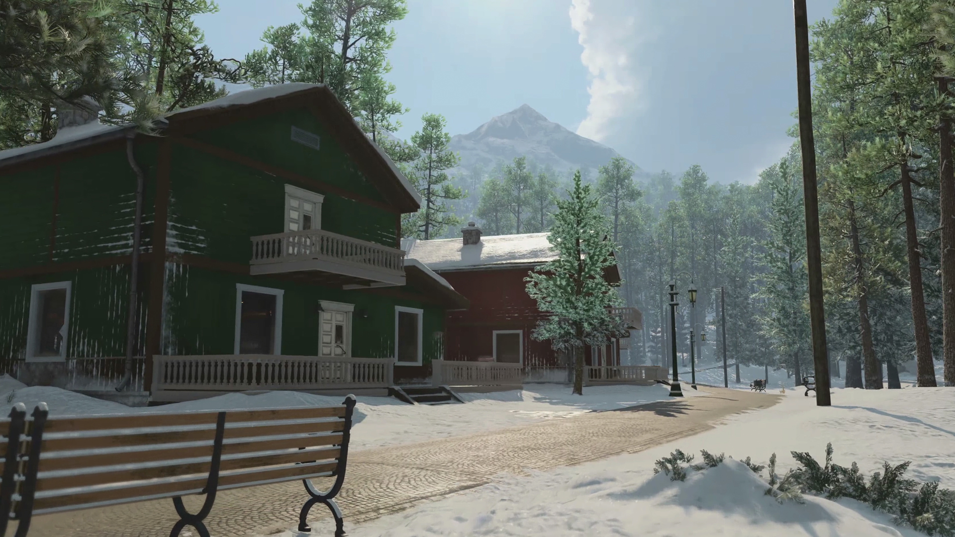 Call of Duty Black Ops Cold War multiplayer maps: A quaint town in a snowy forest, with two large houses and a bench at the center of the image. 