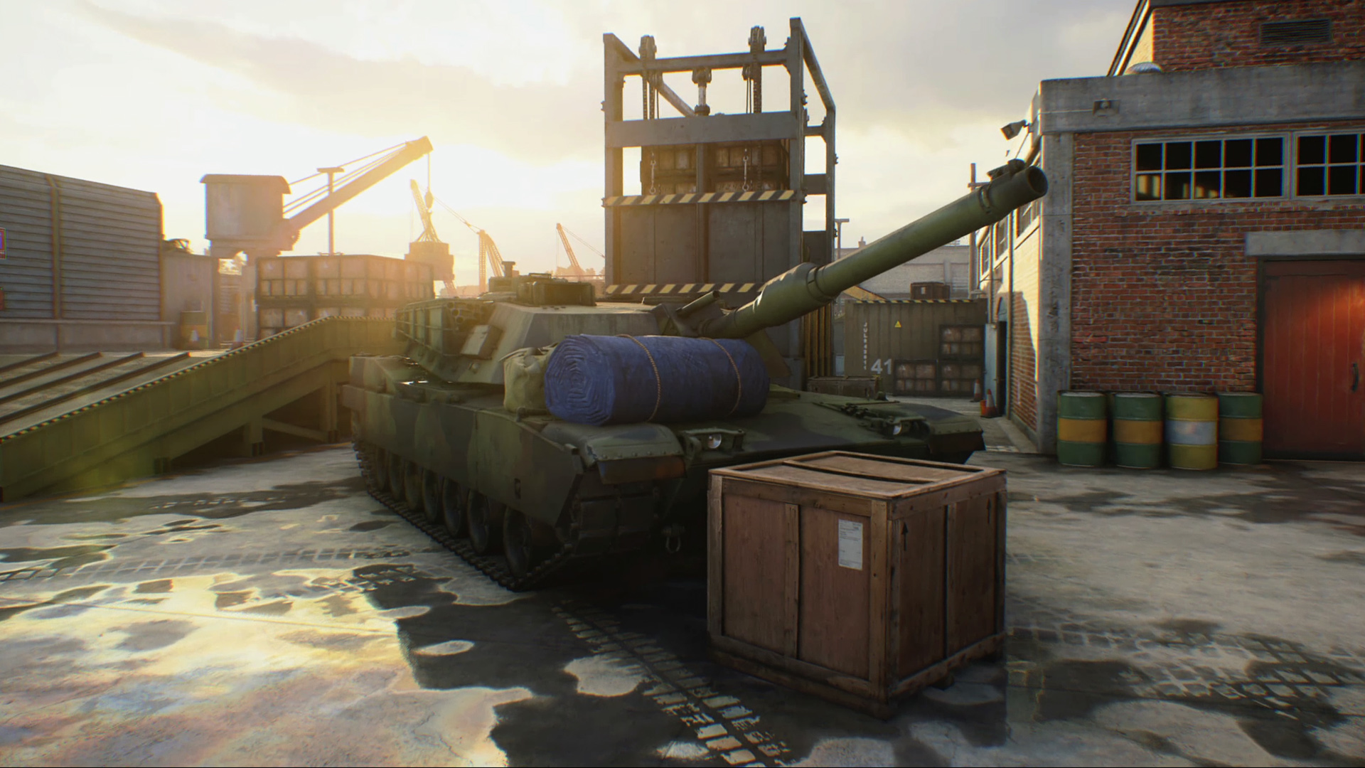 Call of Duty Black Ops Cold War multiplayer maps: A tank surrounding by boxes, barrels, and more in a military garrison.