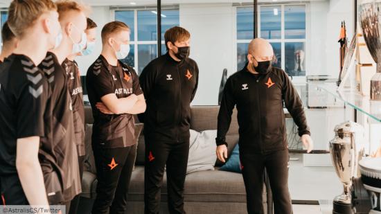 Astralis' CS:GO talent team looking at the team's trophy cabinet