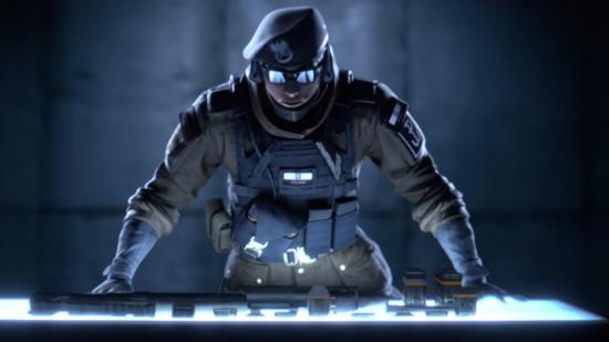 Rainbow Six Siege's Zofia in a darkly lit room with her hands on a table and looking menacing