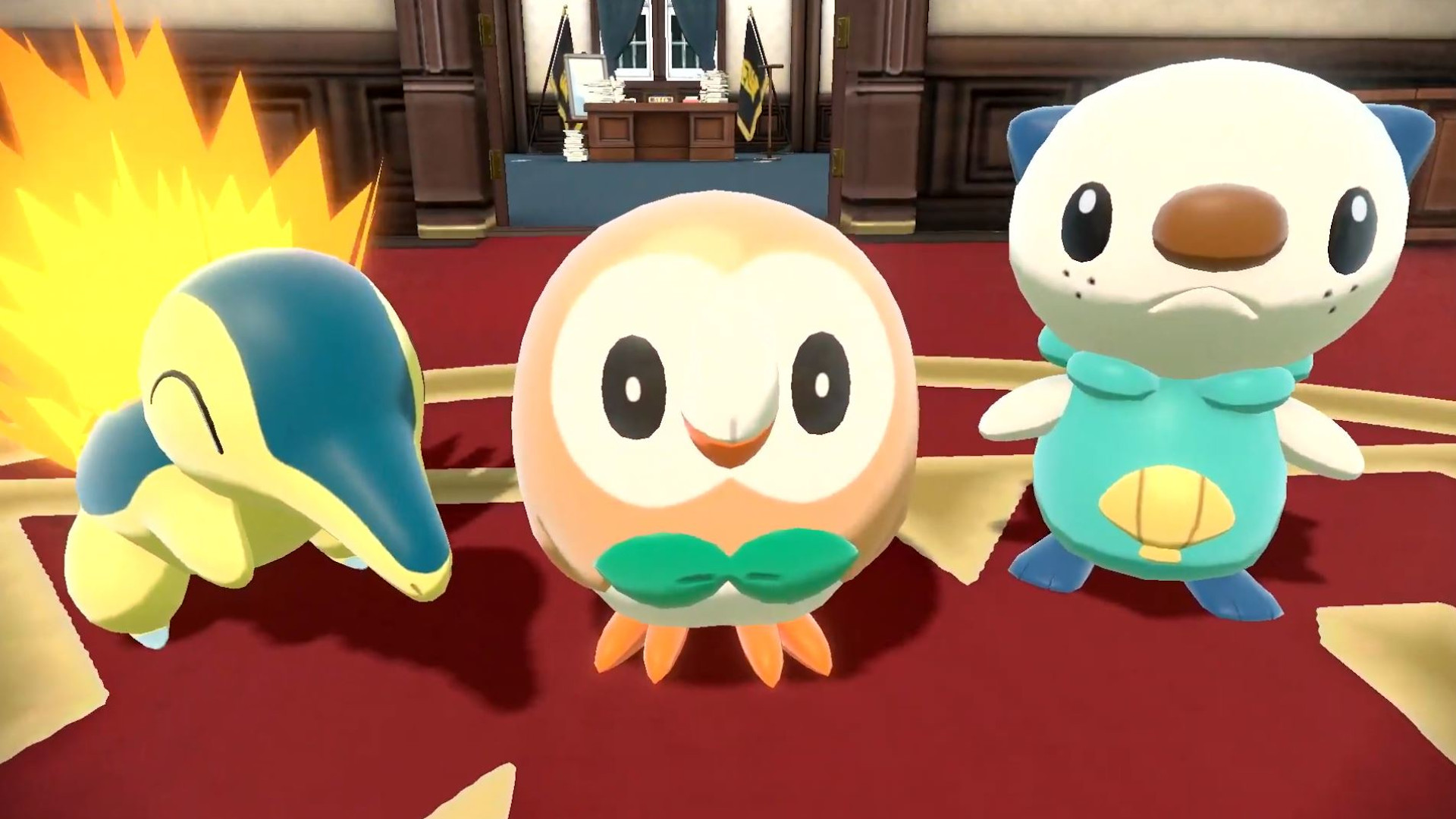 Pokémon Legends Arceus: Cyndaquil, Rowlet, and Oshawott standing next to each other inside an administrative-looking building with red carpet.