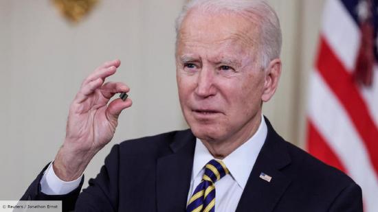 US President Joe Biden holds up a tiny semiconductor