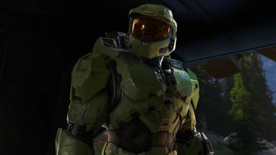 Master Chief stands in a cave and looks to the left of camera