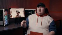 Atlanta FaZe player Arcitys wearing a white, blue, and red hoodie with a PC setup in the background