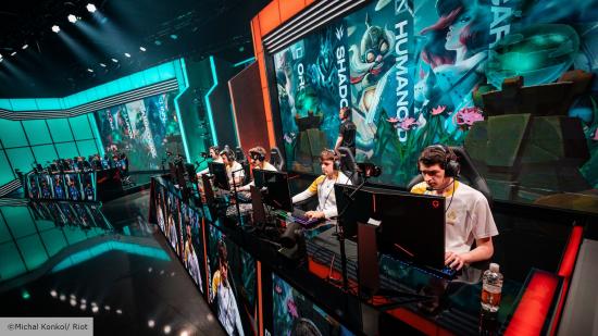 Players competing in the LEC Studio in Berlin. Players are sat behind black gaming monitors, with screens behind displaying the champion they're playing