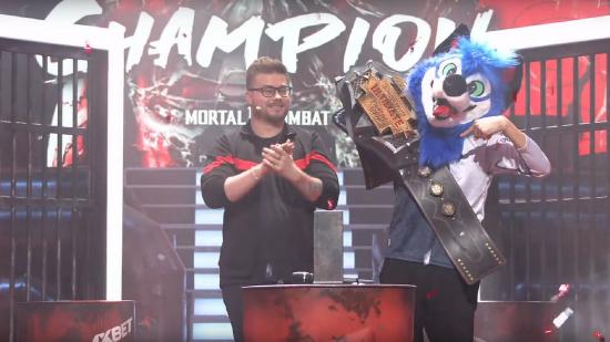 SonicFox lifts the WUFL champions belt while wearing their blue fursuit fox head