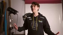 Call of Duty pro Clayster, wearing a black hoodie with yellow hood strings, with his arms outstretched