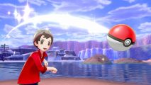 A Pokémon trainer throws a PokéBall, a lake is in the background