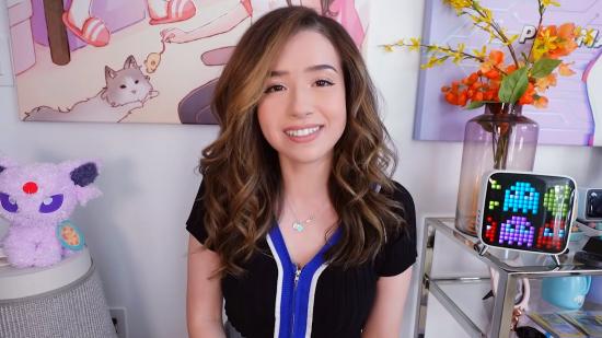 Twitch streamer Pokimane looking down the camera, wearing a black and blue top