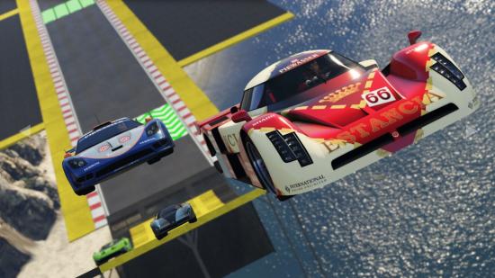 Two race cars speed along a GTA racetrack