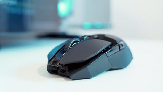 A black wireless gaming mouse on a white table top