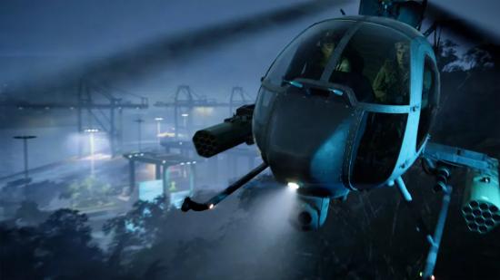 A Battlefield 2042 vehicle: a black helicopter flying through the night sky with a spotlight on the front