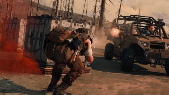 A Warzone operator crouches for cover behind a loadout drop, while and enemy team in buggy open fire