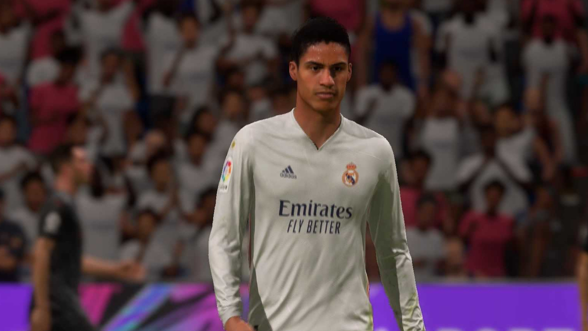 FIFA 22 best CBs: Varane walks across the pitch in a white Real Madrid shirt.