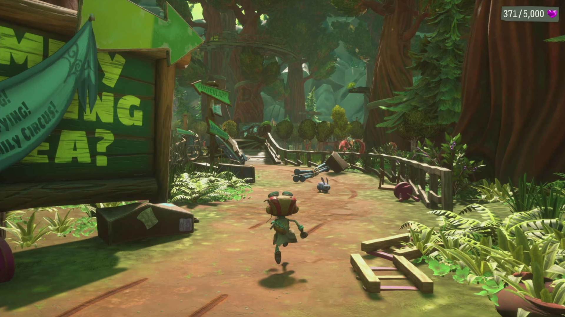 Psychonauts 2 Aqauto family location: Raz can be seen running along a path through the woods, with the fence and other items strewn about.