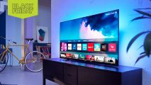 Black Friday best TV deals: A 4K TV on a stand with blue backlighting