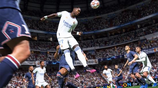 A player in an all-white football kit leaps to head the ball in FIFA 22