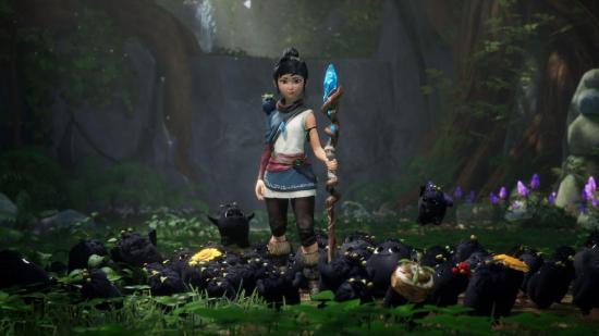 Kena can be seen holding her staff and standing around her Rot.