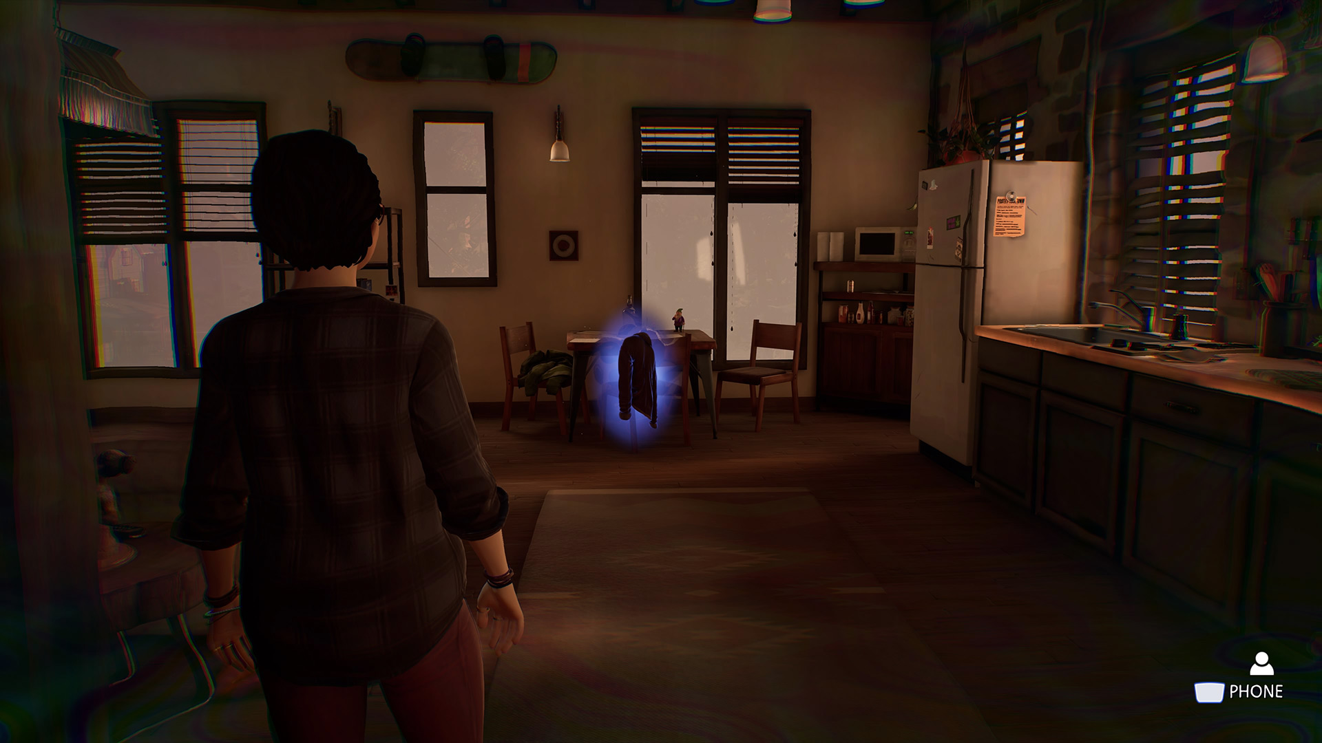 Life is Strange True Colors memory locations: Alex looking at a jacket hanging on the back of a chair in the kitchen.