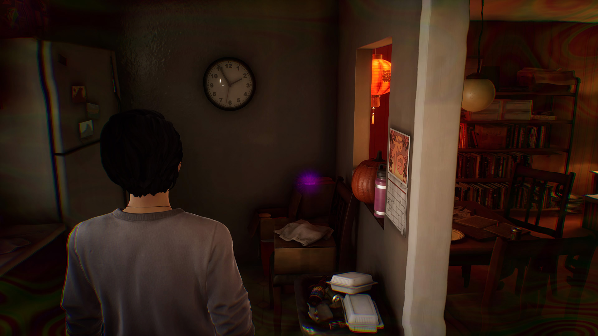 Life is Strange True Colors memory locations: Alex looking at a small business card in the corner of the messy kitchen.