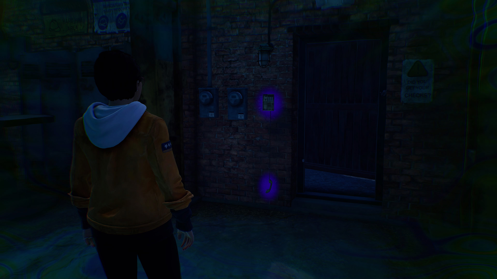 Life is Strange True Colors memory locations: Alex looking at a glowing telephone hanging on the wall.