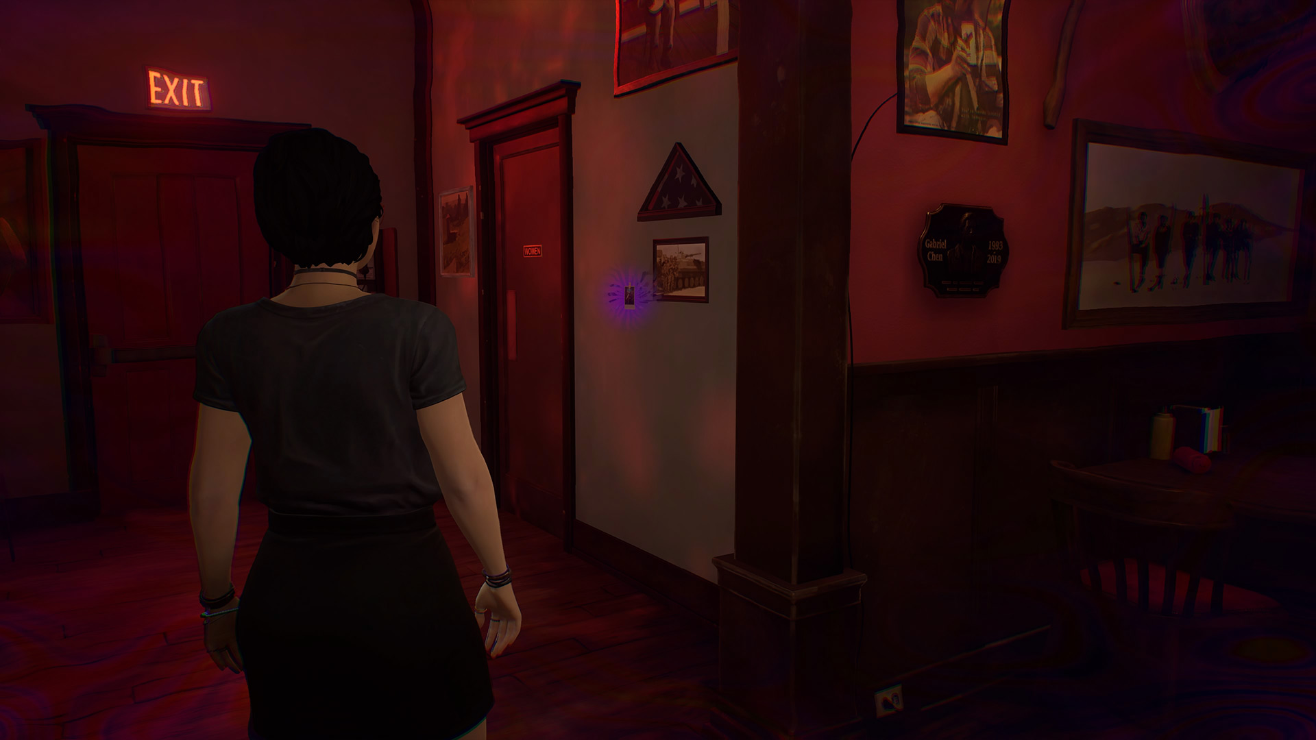 Life is Strange True Colors memory locations: Alex looking at a small polaroid on the wall.