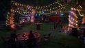 Haven's spring festival in Life is Strange: True Colors, featuring trees criss-crossed with lights and mingling guests