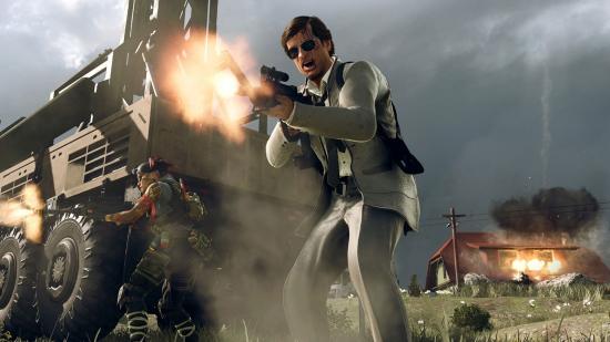 An operator in black sunglasses and a white suit shouts and fires an assault rifle. A house explodes on the background