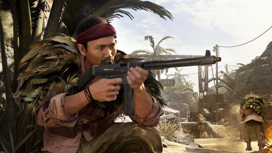 Vanguard weapon codenames: An operator wielding a Vanguard gun in Warzone crouches next to a palm tree with his weapon drawn