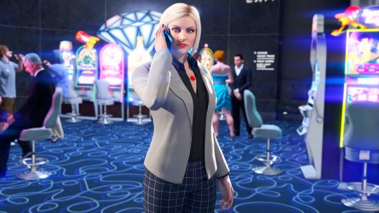 GTA Online Criminal Enterprises: A woman with blonde hair and a grey suit jacket talks on the phone in GTA Online's casino