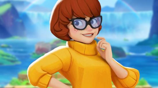 MultiVersus Velma Combos: an image of a red-haired woman in an orange turtleneck sweater