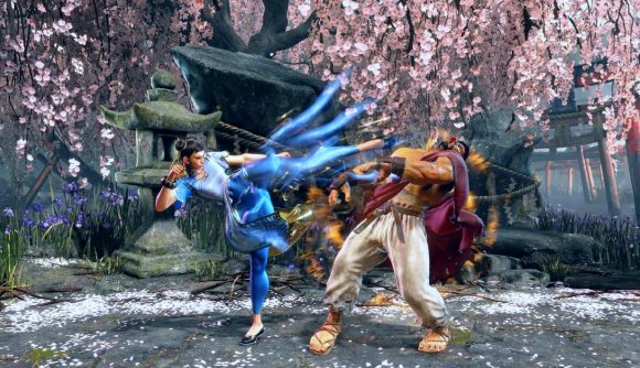 Street Fighter 6 Evo 2022: Two fighters brawl in front of cherry blossom trees in SF6