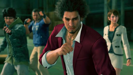 Yakuza PS Plus games: A man in a red suit raises his fist in a fighting stance