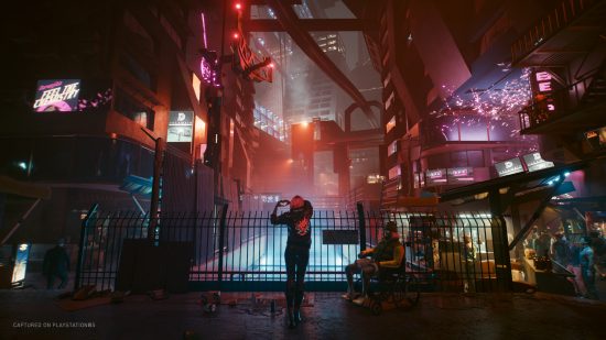 PS5 open world games: a tourist takes a photo of the neon-light streets in Cyberpunk 2077's Night City