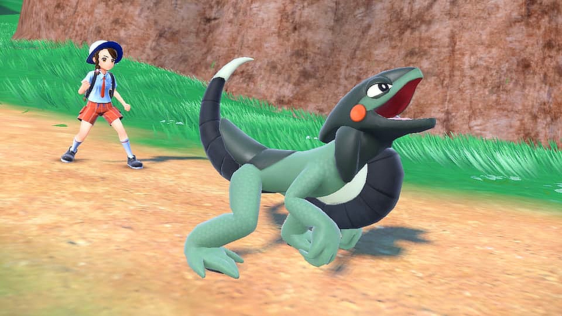 Pokemon Scarlet and Violet new pokemon: Cyclizar, a green and black lizard Pokemon, roars with its trainer in the background