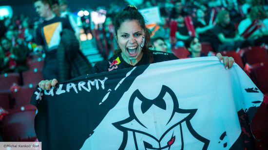 League of Legends Game Changers: A G2 fan shouts and holds up a flag with the team's logo on it