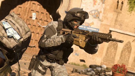 Best LMG in Modern Warfare 2: A soldier wearing body armour and a helmet holds up a hefty LMG