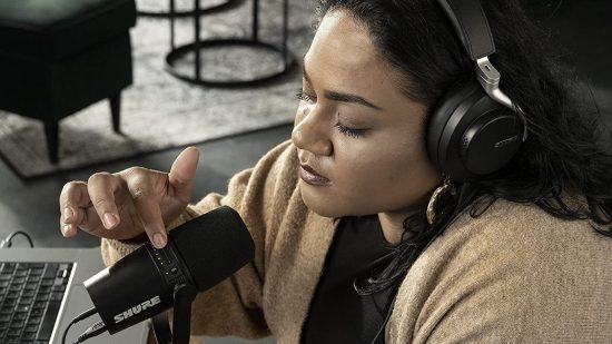 Shure MV7 USB microphone being used by a feminine looking person in their home.