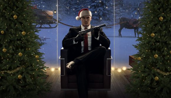 Best Christmas games: Agent 47 wearing a christmas hat sits in a chair and holds his silenced pistol