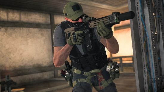 Warzone 2 Season 2 release time: A man in military gear points an assault rifle around a corner