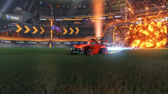Best crossplay games: A car driving away from an explosion on a football pitch in Rocket League.
