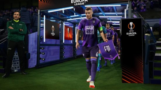 Best Football Games: A captain in a purple jersey leads his players out of the tunnel in Football Manager 2023