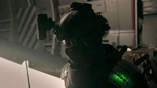 Warzone 2 DMZ extraction shooter formula: A soldier, wearing a helmet with night vision goggles attached. looks down in the cargo area of a plane