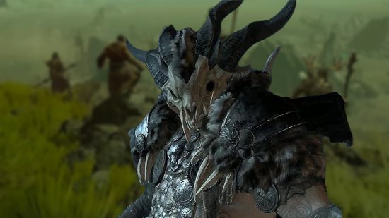 Diablo 4 Druid build: A male Druid wearing bone armor against a blurred background of a coastal environment.