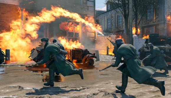 Best cross-play games: Enlisted. Image shows soldiers running on an urban battlefield, with flames spewed behind them.