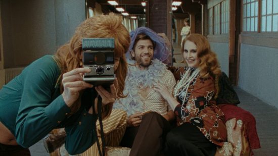Best games: A woman takes a polaroid picture of herself and two friends in Immortality