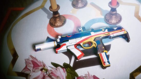 Destiny 2 The Title god roll: The Guardian Games themed The Title SMG resting on a colourful cloth next to flowers and candles.